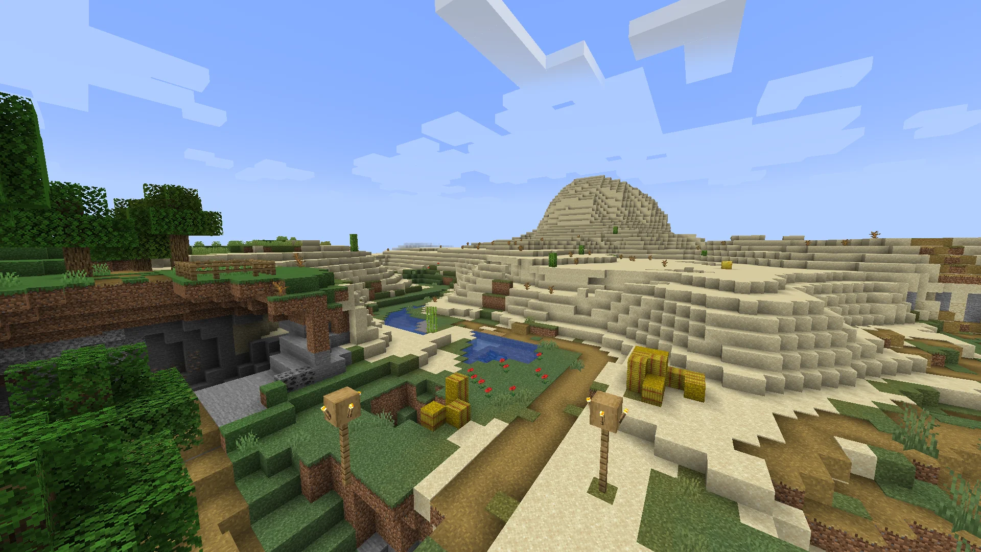 Vanilla Minecraft Village with view of tall desert hill